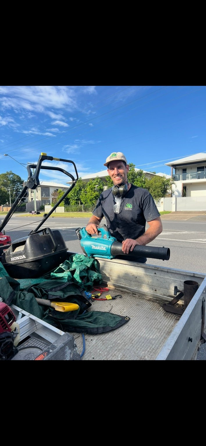 Green & Grit team member with mowing equipment
